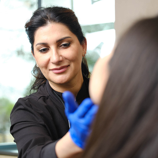 Dr. Marjan Shaghasi examining a patient